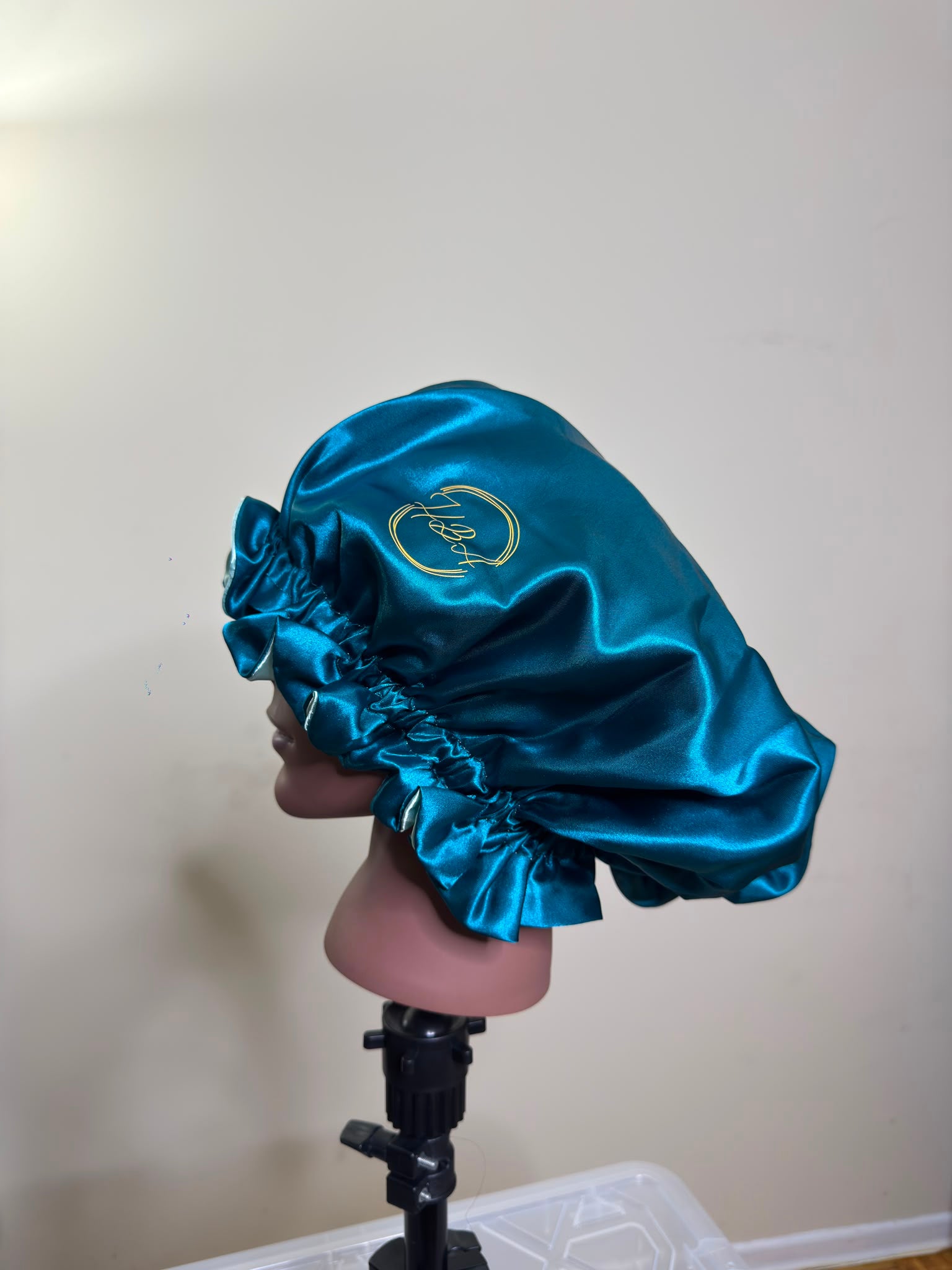 House of Adjeh luxury satin bonnet with the embroidered brand crest