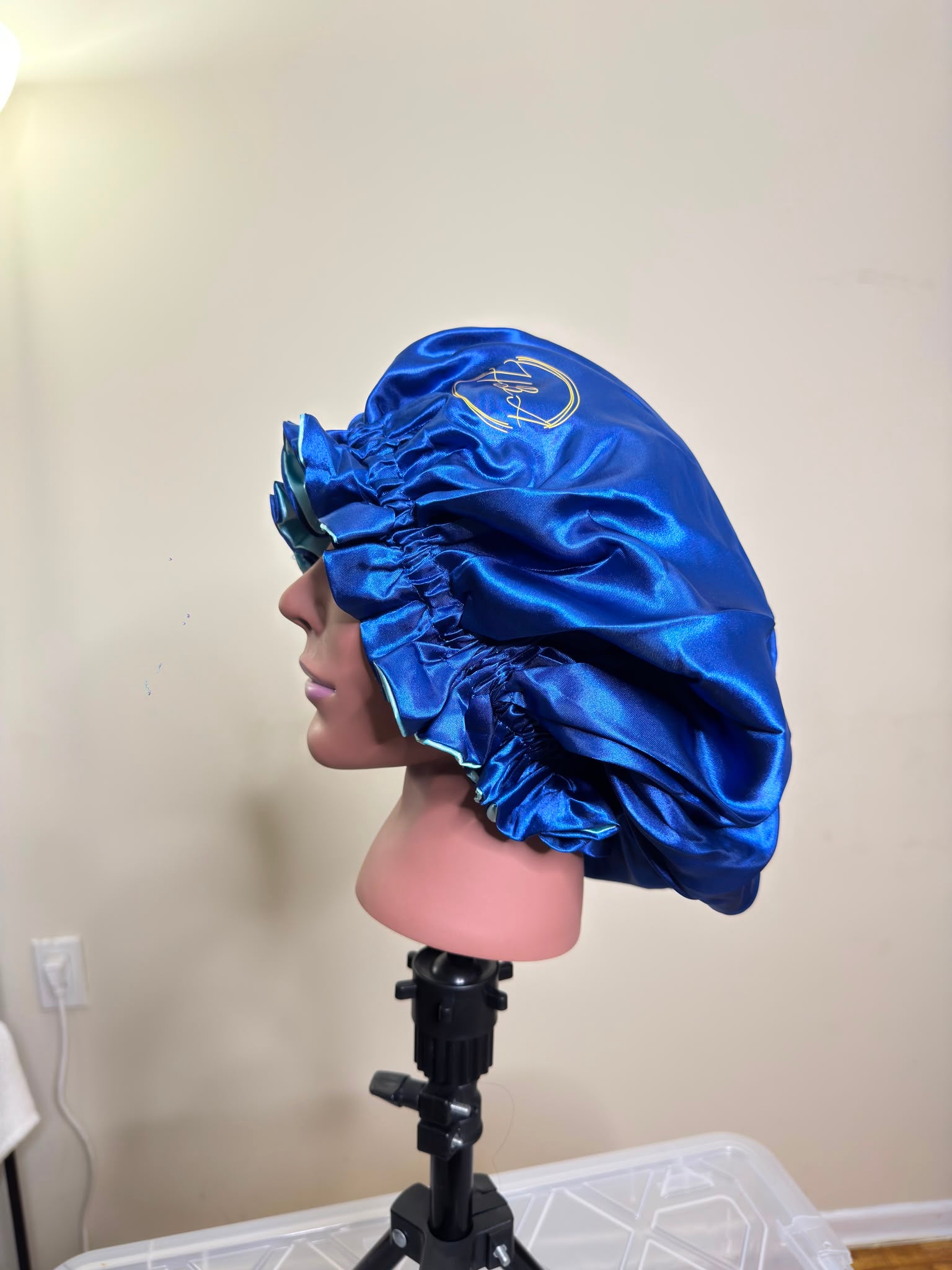 House of Adjeh luxury satin bonnet in blue, shown on a mannequin head